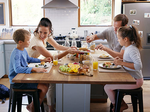 Photo: A family eating together at a table.