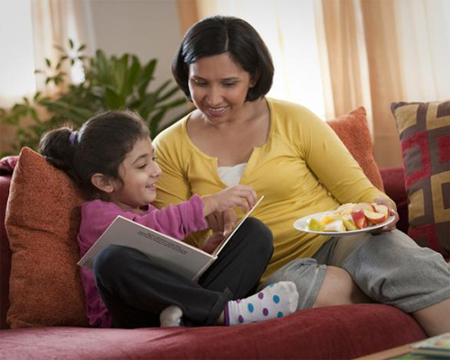 Photo: Mother and daughter reading a book.