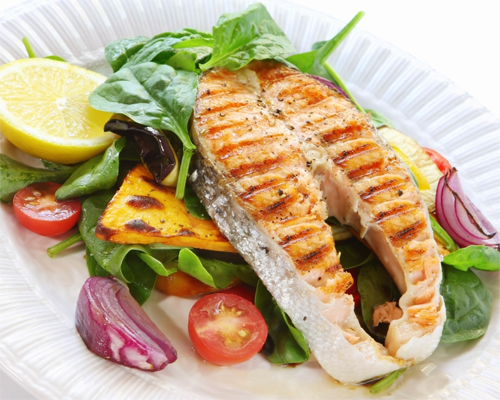 Photo: Grilled salmon on top of grilled vegetables.