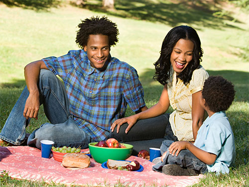 Photo: Family having a picknick in the park.