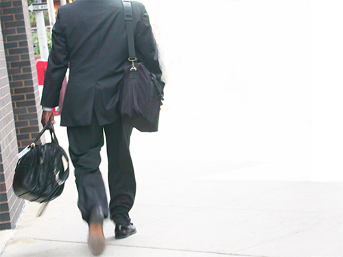 Photo: Adult carrying heavy bags.