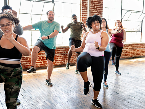 Adults exercising in gym class.