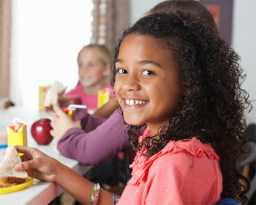 Photo: Girl eating lunch.