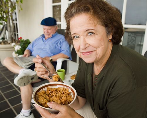 Photo: Senior couple breakfasting on porch.