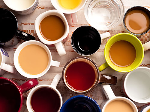 Photo: glasses and cups filled with beverages.