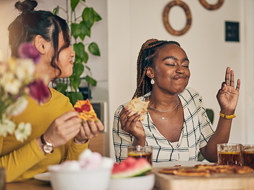 Friends eating together at gathering.