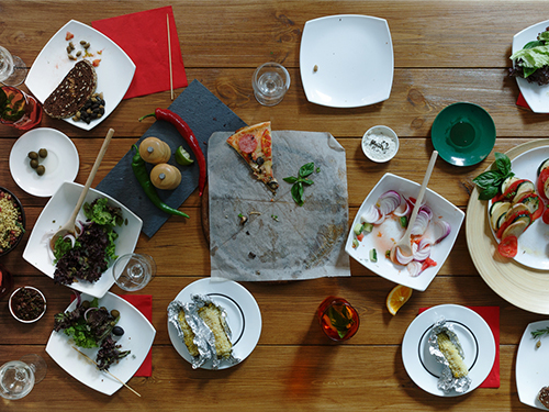 Photo: After party wasted foodon wooden festive table.