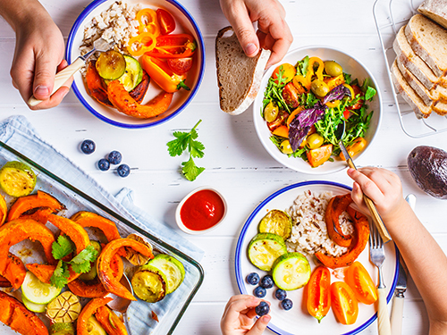 Photo: Healthy vegetarian food arranged and served on a table.