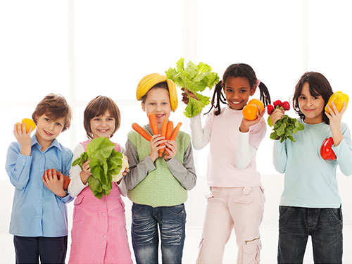 Photo: Group of children holding fruits and vegetables.