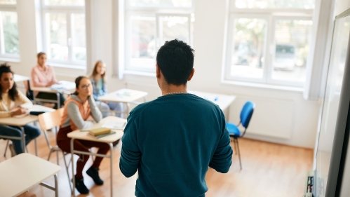 A teacher in the classroom with students.