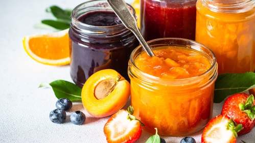 Homemade jams, natural preservation in glass jars with ingredients, fresh fruits and berries.