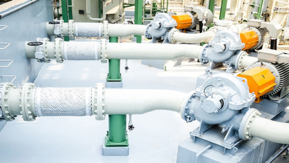 White pipes and turbines are portrayed at a water utilities center.
