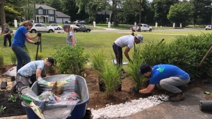 A group of people building a rain garden.