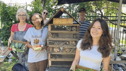 Several people holding produce.