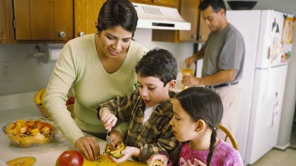 A family making a fruit salad.