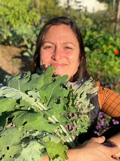 Cecilia Diaz holding collards.