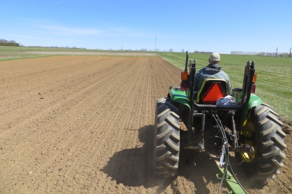 Tractor planting in field.
