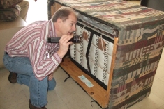 Examining a sofa for bed bugs.